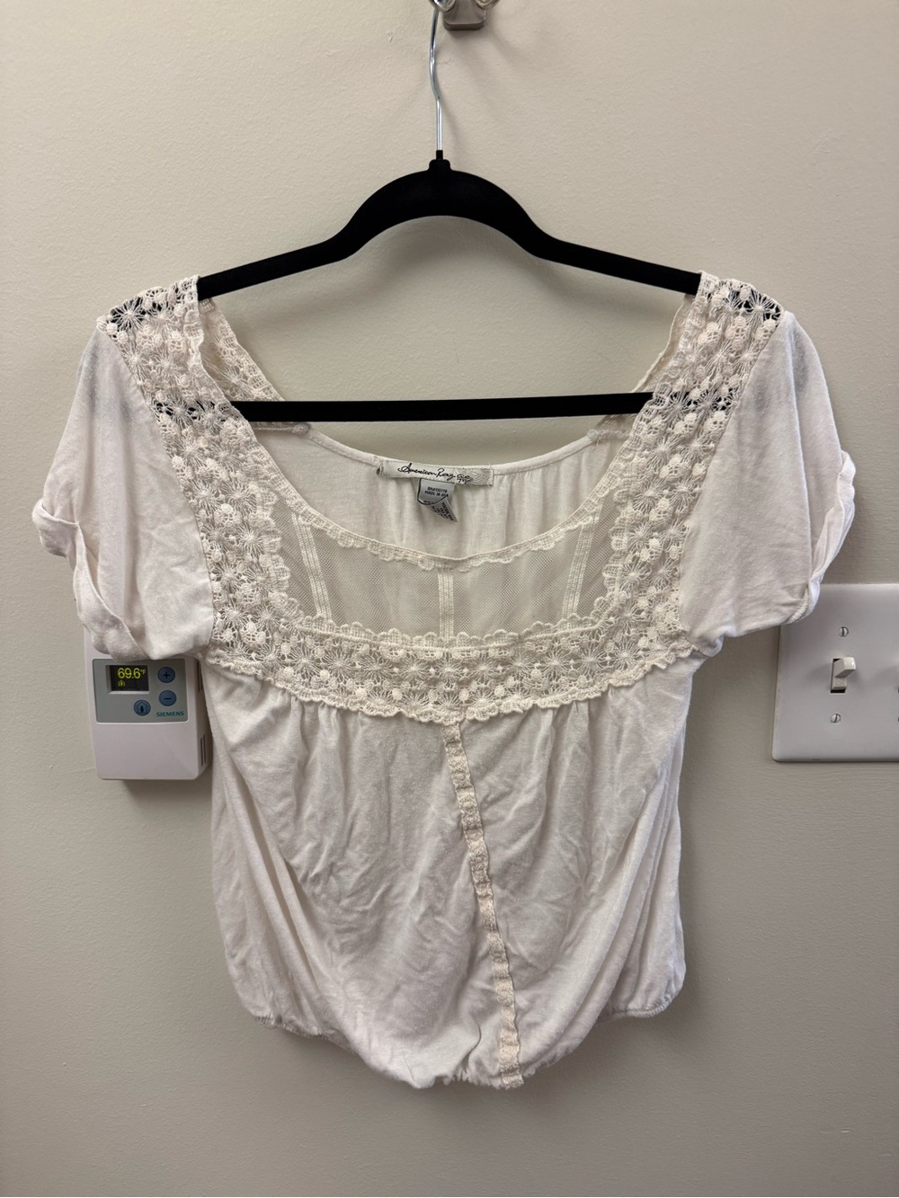 white top with lace detail and mesh paneling